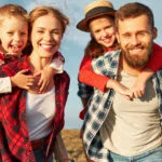 Happy young loving couple outside with backpack in free vacation camping